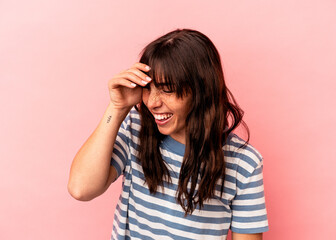 Young Argentinian woman isolated on pink background joyful laughing a lot. Happiness concept.