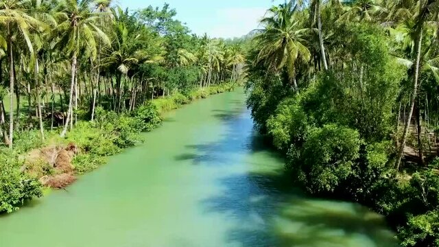 Drone flying over pristine Maron river in Pacitan, East Java, Indonesia. Aerial panoramic view