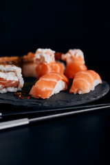 sushi on a plate black background