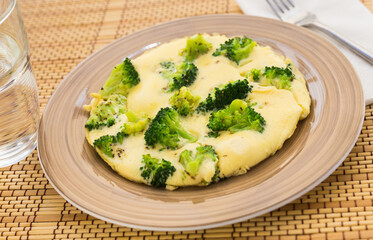 wholesome breakfast. omelet with broccoli on brown plate