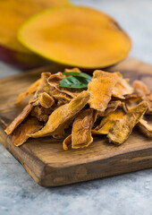 Dried mango background. Candied slices of mango fruit close-up.