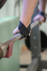 Athlete's hands with a barbell in the gym