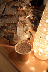 Paper cup with coffee and powdered sugar