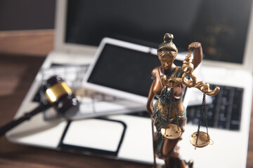 Lady Justice Statue with a judge gavel, tablet and computer.