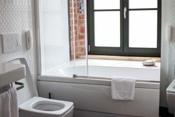 Loft style bathroom design with a large window