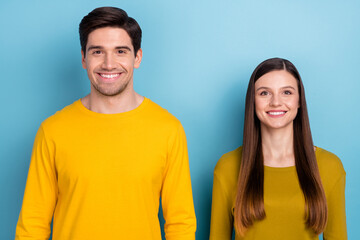 Photo of cheerful positive people shiny beaming smile wear yellow casual outfit isolated blue color background