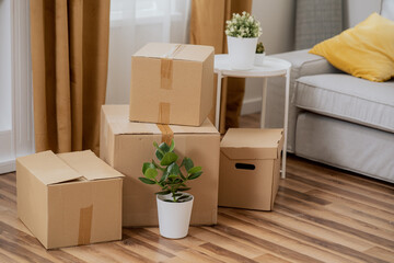 Moving in out, cardboard boxes with packed things, renting selling an apartment, changing location