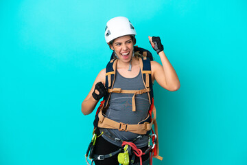 Young Italian rock-climber woman isolated on blue background celebrating a victory