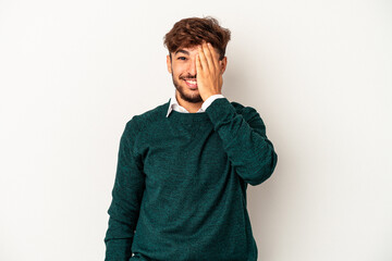 Young mixed race man isolated on grey background having fun covering half of face with palm.