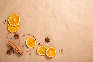 Christmas composition with dried oranges and spices on craft paper. Top view, flat lay, copy space....