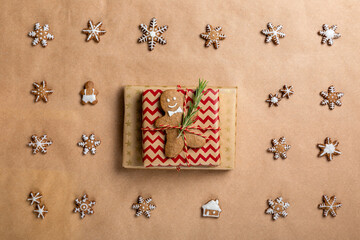 Christmas composition with gifts and  gingerbread cookies on craft paper. Top view, flat lay. Winter holidays background. Christmas or New Year concept.