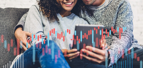 Successful of business trader investor couple use technology tablet trading graph of block chain stock market cryptocurrency investment selling and buying with technical price chart data graph