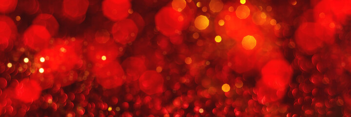 Red and golden sparkling glitter bokeh background, christmas texture. Holiday lights. Abstract defocused header. Wide screen wallpaper. Panoramic web banner with copy space for design