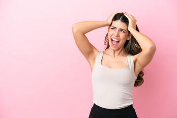 Young Italian woman isolated on pink background stressed overwhelmed