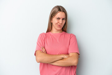 Fototapeta premium Young caucasian woman isolated on blue background frowning face in displeasure, keeps arms folded.