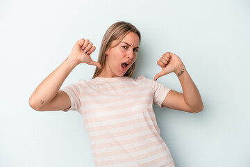 Young caucasian woman isolated on blue background feels proud and self confident, example to follow.