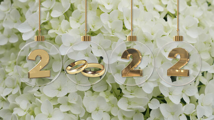 white wedding golden rings in transparent glass christmas bauble 2022 digits on white hortensia...