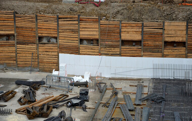 concreting the floor of underground garages with the help of a mixer and a pump with a hose. concrete reinforcement wires are entwined in a gray mesh. monolithic constructions of large buildings