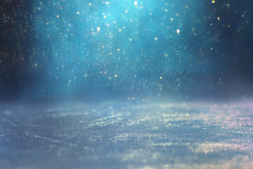 background of abstract glitter lights. gold, blue and silver. de focused