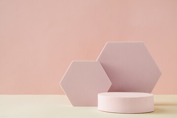 Hexagonal and round shapes against pink background