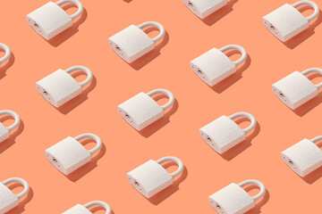 Pattern from padlock on trendy coral background. Minimal concept of protection and security.