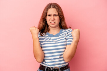 Little caucasian girl isolated on pink background upset screaming with tense hands.