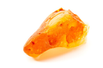 Natural amber. A piece of yellow opaque natural amber on white background.