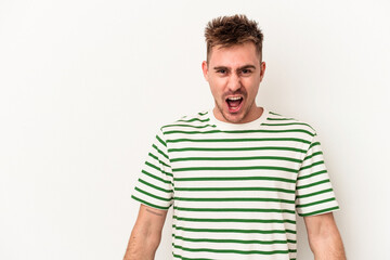 Young caucasian man isolated on white background shouting very angry, rage concept, frustrated.