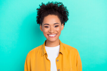 Photo of beautiful adorable lady wear yellow shirt smiling isolated teal color background
