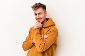 Young caucasian man isolated on white background smiling happy and confident, touching chin with hand.