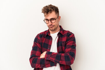 Young caucasian man isolated on white background unhappy looking in camera with sarcastic expression.