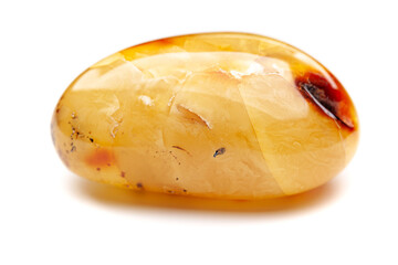 Natural amber. A piece of yellow opaque natural amber on white background.