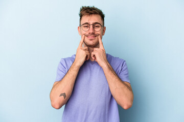 Young caucasian man isolated on blue background doubting between two options.