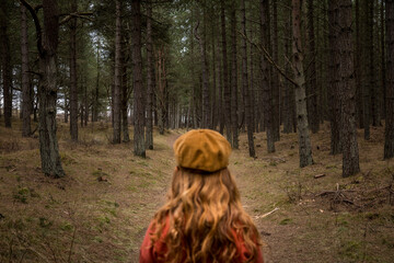 Ginger haired girl walking in woods
