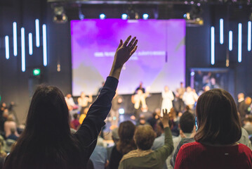 Hands in the air of people who praise God at church service - 472035104