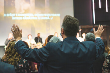 Hands in the air of people who praise God at church service