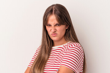 Fototapeta premium Young caucasian woman isolated on white background frowning face in displeasure, keeps arms folded.