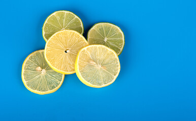 Round slices of lemon on a blue background. Space for text. Pattern