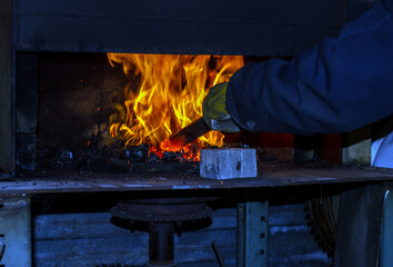 The blacksmith heats the metal to just the right temperature before hand forging it into the...