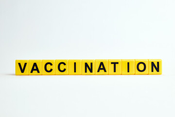 The word vaccination consists of individual cubes with letters.