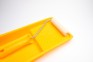 Paint roller and paint tray on a white background. Paint walls