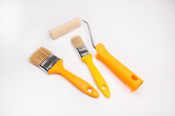 Paint roller, clean brushes on a white background. Painting tools. Constuction tools lie on a white background