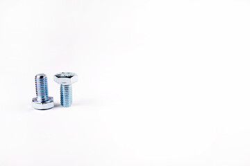 Two small bolts on a white background. Inverted bolts. Metaphor of various people. A different look...