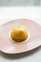 Mango and passion fruit mousse decorated with white chocolate