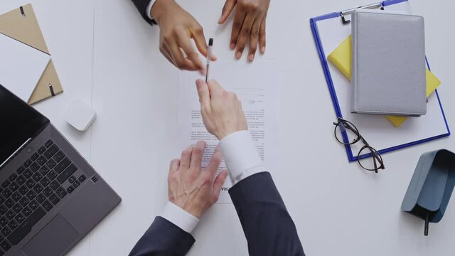 Man and woman signing business contract with lorem ipsum text, shaking hands