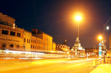 Light paths from headlights on the background of the central part of the city