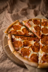 Delicious, aromatic, hot pepperoni pizza on brown background