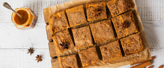 Spicy Pumpkin Cbars Blondie Squares with Cinnamon, Anise and Caramel. Traditional English Dessert. Top view - obrazy, fototapety, plakaty