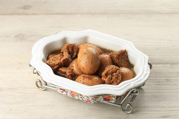 Semur Telor is Boiled Eggs Cook with Soy Sauce for Family Menu on White Table