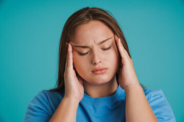 Young white woman with headache rubbing her temples